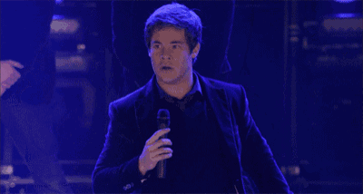 a man in a suit is standing with his arms outstretched