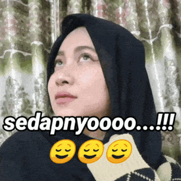 a woman wearing a black hijab with the words sedapnyoooo !!! below her