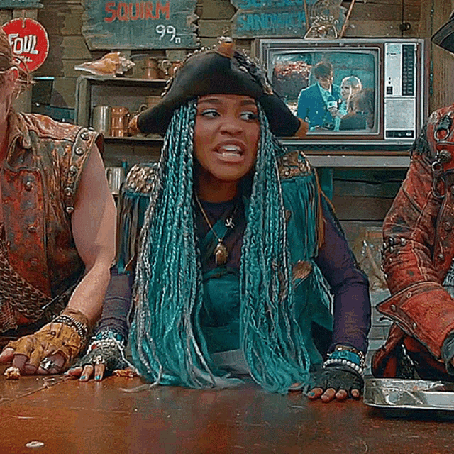 a woman with blue braids sits in front of a sign that says squirem 99