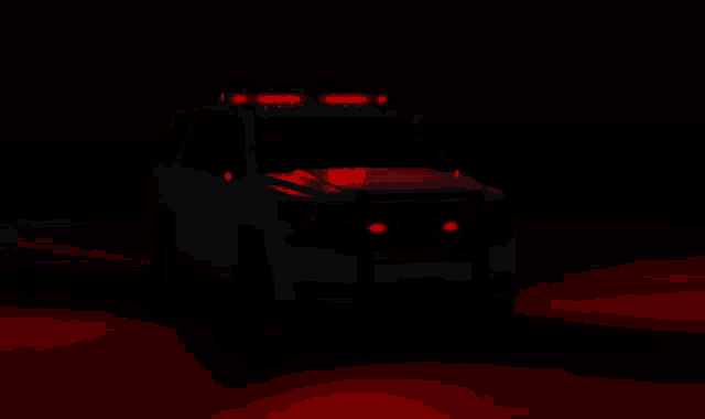 a police car with red lights on the hood