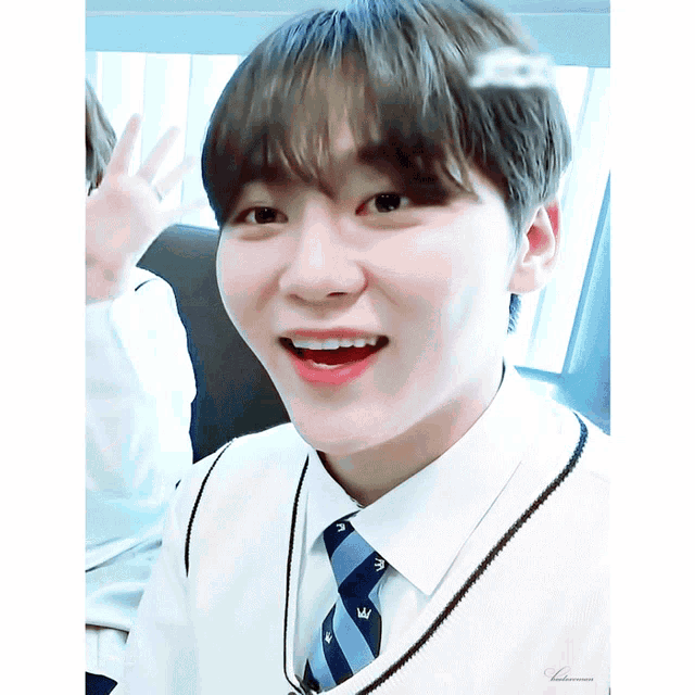 a close up of a person wearing a tie and a white shirt