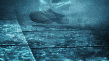 a person 's feet are visible in a foggy scene