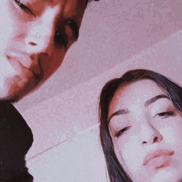 a close up of a man and a woman 's faces