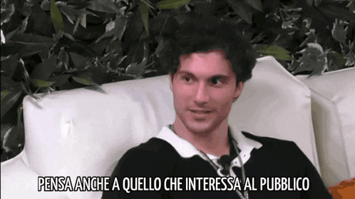 a man sitting on a couch with the words pensa anche a quello che interessa al pubblico written below him