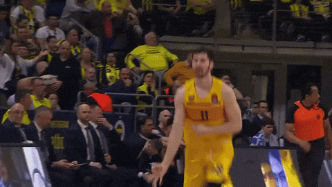 a basketball player wearing a number 11 jersey stands in front of a crowd
