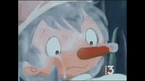 a close up of a cartoon character with a red nose and a tear running down his face .