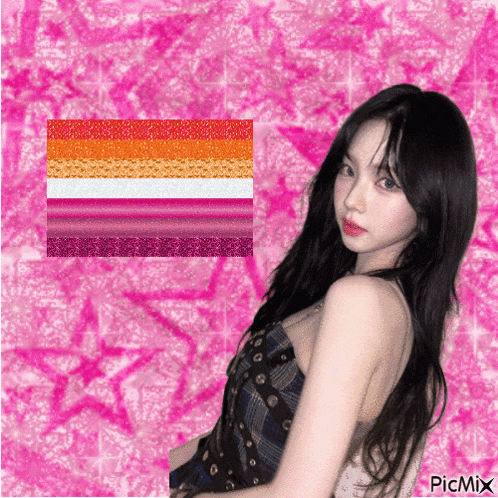 a girl is standing in front of a pink background with a lesbian flag behind her