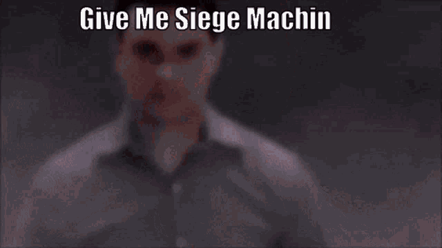 a close up of a man 's face with the words give me siege machin on it