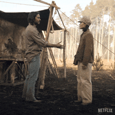 two men standing in a field with netflix written on the bottom