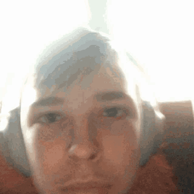 a close up of a person 's face with the sun shining through it