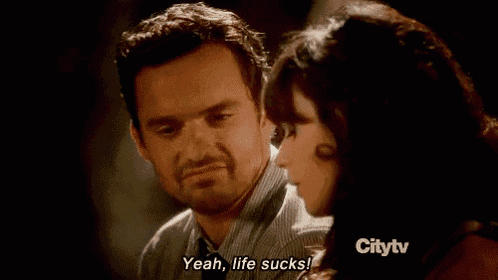 a man and a woman are looking at each other and the man is saying yeah life sucks
