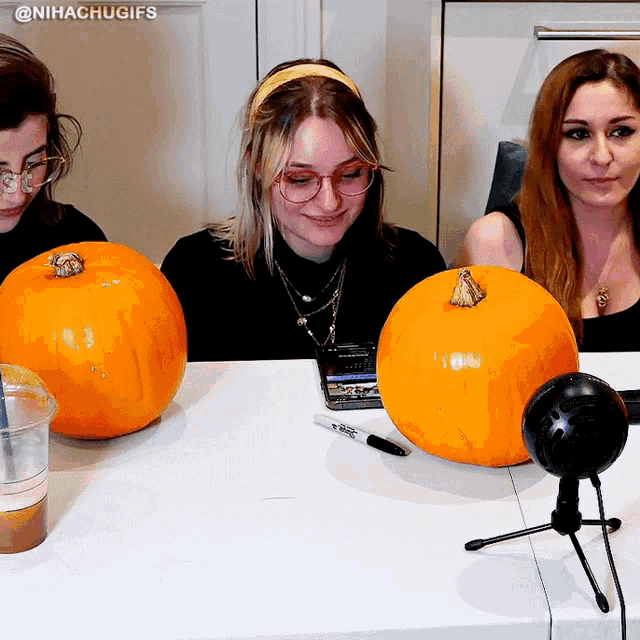 three women are sitting at a table with pumpkins and a microphone with the hashtag @nihachugafs