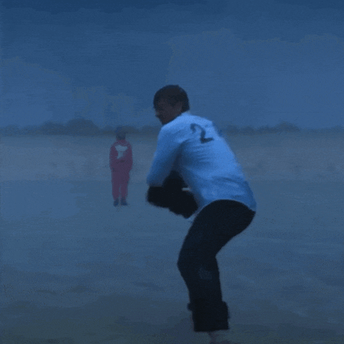 a man wearing a blue shirt with the number 9 on the back