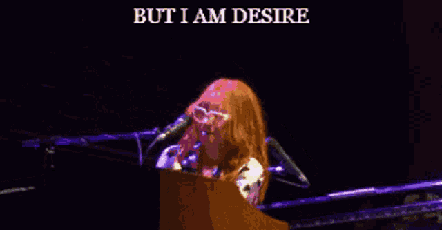 a woman singing into a microphone with the words but i am desire written above her