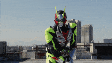 a man in a superhero costume is standing on a rooftop with a city in the background