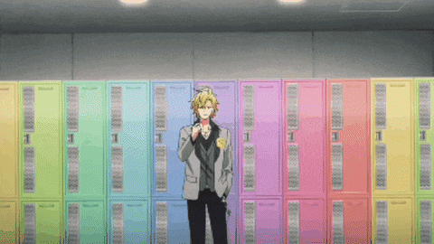 a man in a suit stands in front of a row of colorful lockers with the number 1 on them