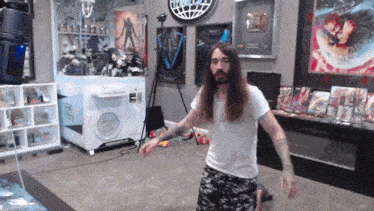 a man with long hair and a beard stands in front of a machine that says lucky draw