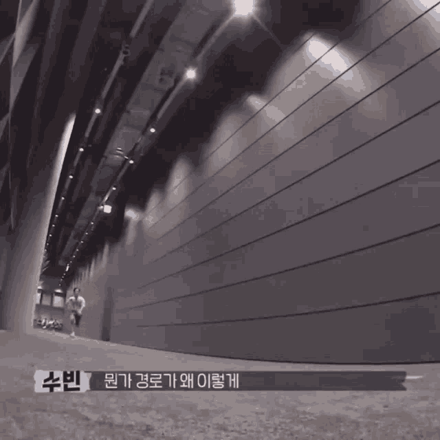 a black and white photo of a tunnel with chinese writing