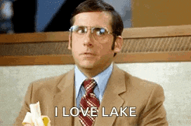 a man in a suit and tie is eating a banana while saying i love lake .