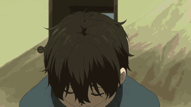 a person with their eyes closed looks down at something in front of a door