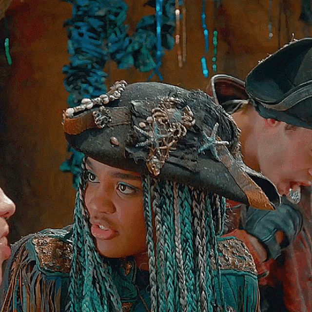 a woman with dreadlocks wearing a pirate hat