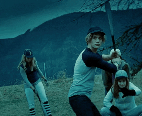 a man wearing a baseball cap with the letter g on it swings a bat