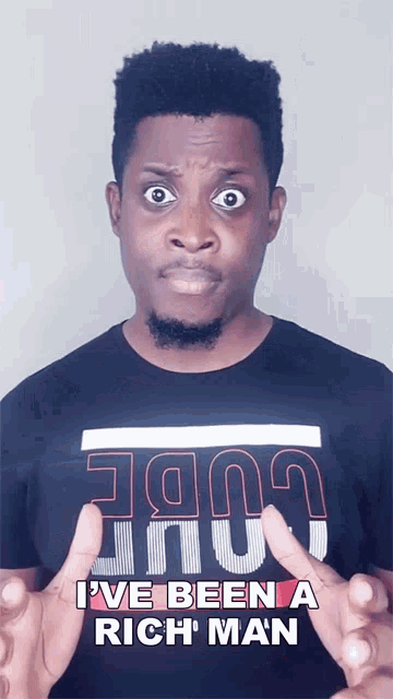 a man wearing a black shirt that says i ve been a rich man