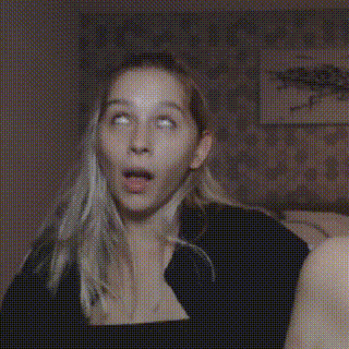 a woman is making a surprised face while another woman looks on