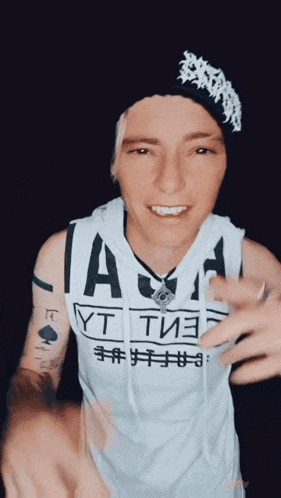 a man wearing a tank top that says " a " on it