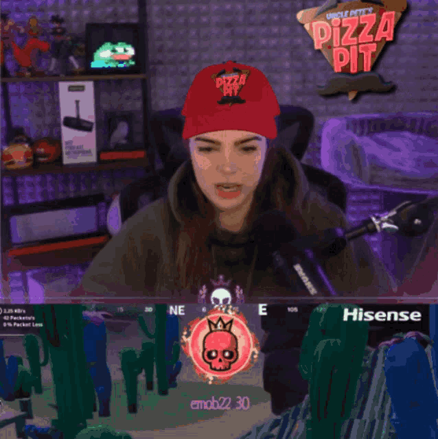 a girl wearing a red hat that says pizza pit