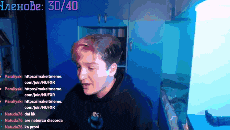 a man in a black hoodie stands in front of a blue wall with a score of 30/40