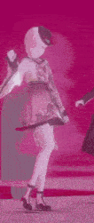 two anime girls are dancing on a stage in a video game .