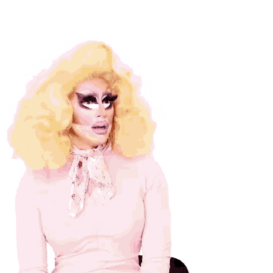 a drag queen is pointing at the word this