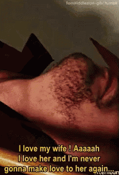 a man with a beard is laying down and says i love my wife