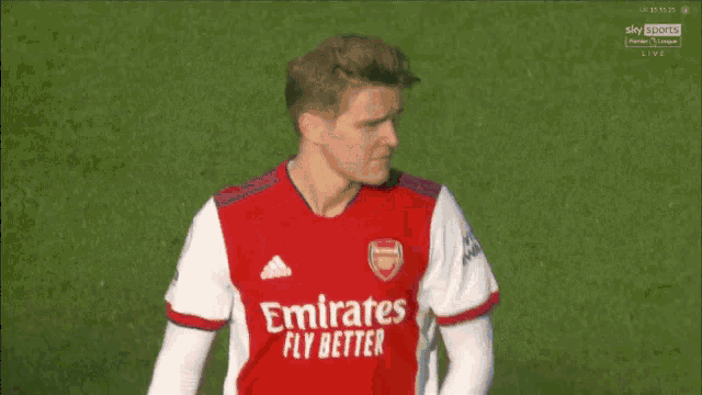 a man wearing a red and white jersey with the word rwan on the sleeves