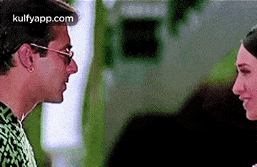 a man and a woman are looking at each other and talking to each other .