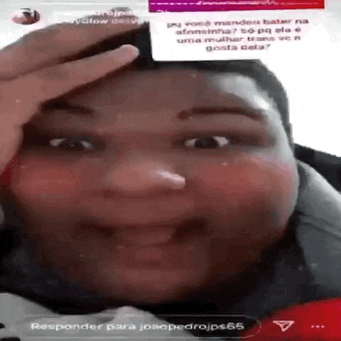 a man is holding his hand to his forehead while smiling