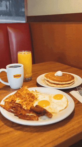 a table topped with plates of food including pancakes and eggs with a cup of jimmy 's coffee
