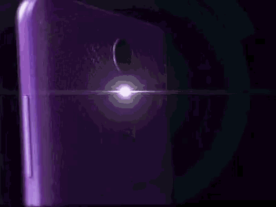 a close up of a purple cell phone with the letter m on it