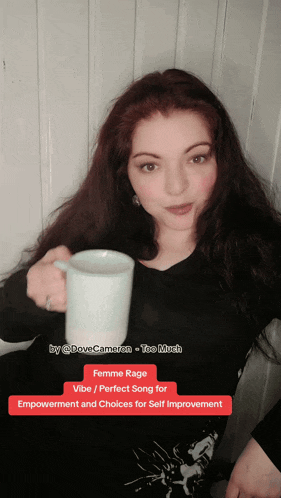 a woman is holding a cup of coffee with the words femme rage vibe / perfect song for empowerment and choices for self improvement