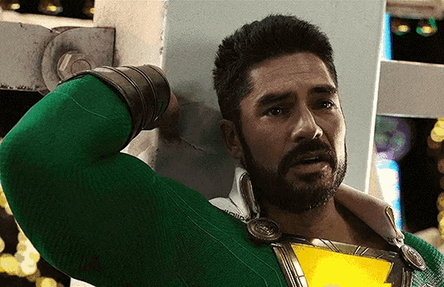 a man with a beard is wearing a green superhero outfit