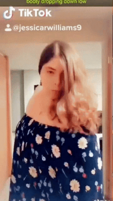 a woman in a floral dress is on a tik tok
