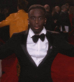 a man is doing a handstand on the red carpet
