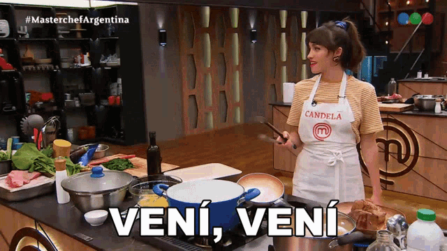 a woman wearing an apron that says candela is cooking