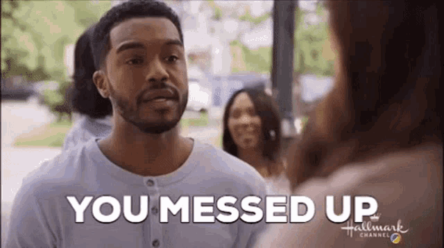 a man with a beard is standing in front of a group of people and saying `` you messed up '' .
