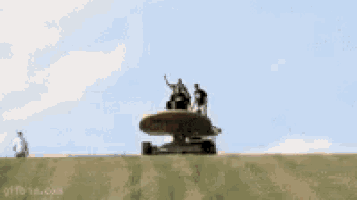 a group of people are riding on top of a skateboard .