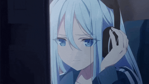 a girl with long blue hair is wearing headphones and looking at a computer screen