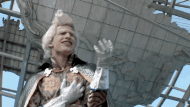 a man in a costume is holding a bottle of water in his hand