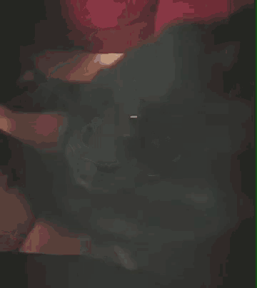 a blurry picture of a person 's face with a red and green border .