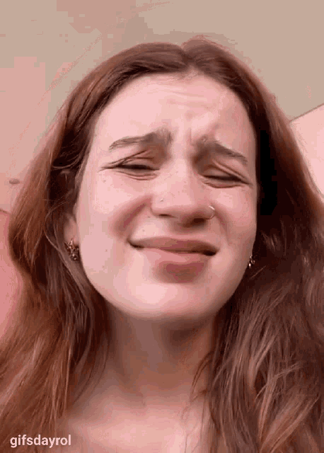 a close up of a woman making a funny face with gifsdayrol written below her